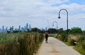 Person walking outdoors as part of everyday movement for fat loss