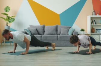 Two people doing push-ups on yoga mats during a short home workout